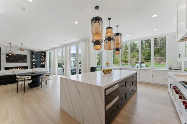 a open kitchen with stainless steel appliances granite countertop a sink and wooden floors