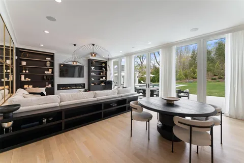 a kitchen with stainless steel appliances granite countertop a stove and a view of living room