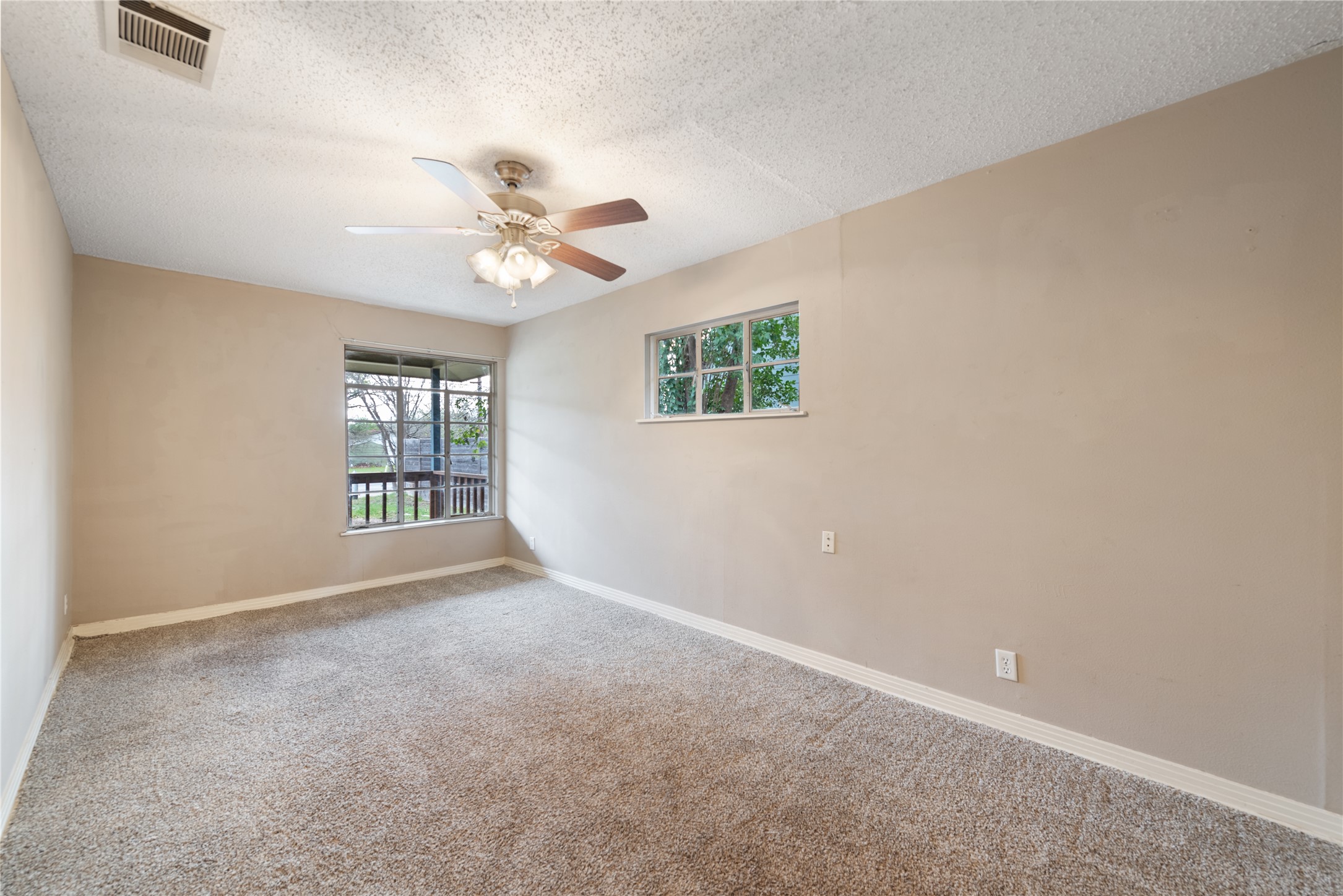1900 Justin Lane Austin, TX 78757 - Photo 11 of 27 Unfurnished room with carpet, a textured ceiling, and ceiling fan
