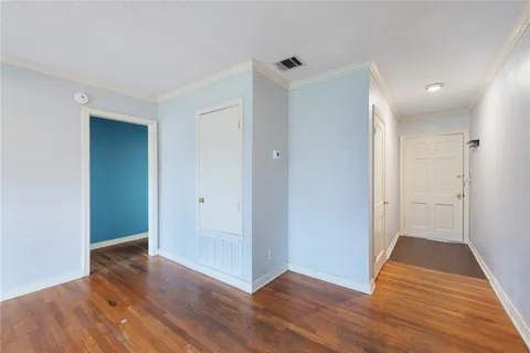 a view of a hallway with wooden floor