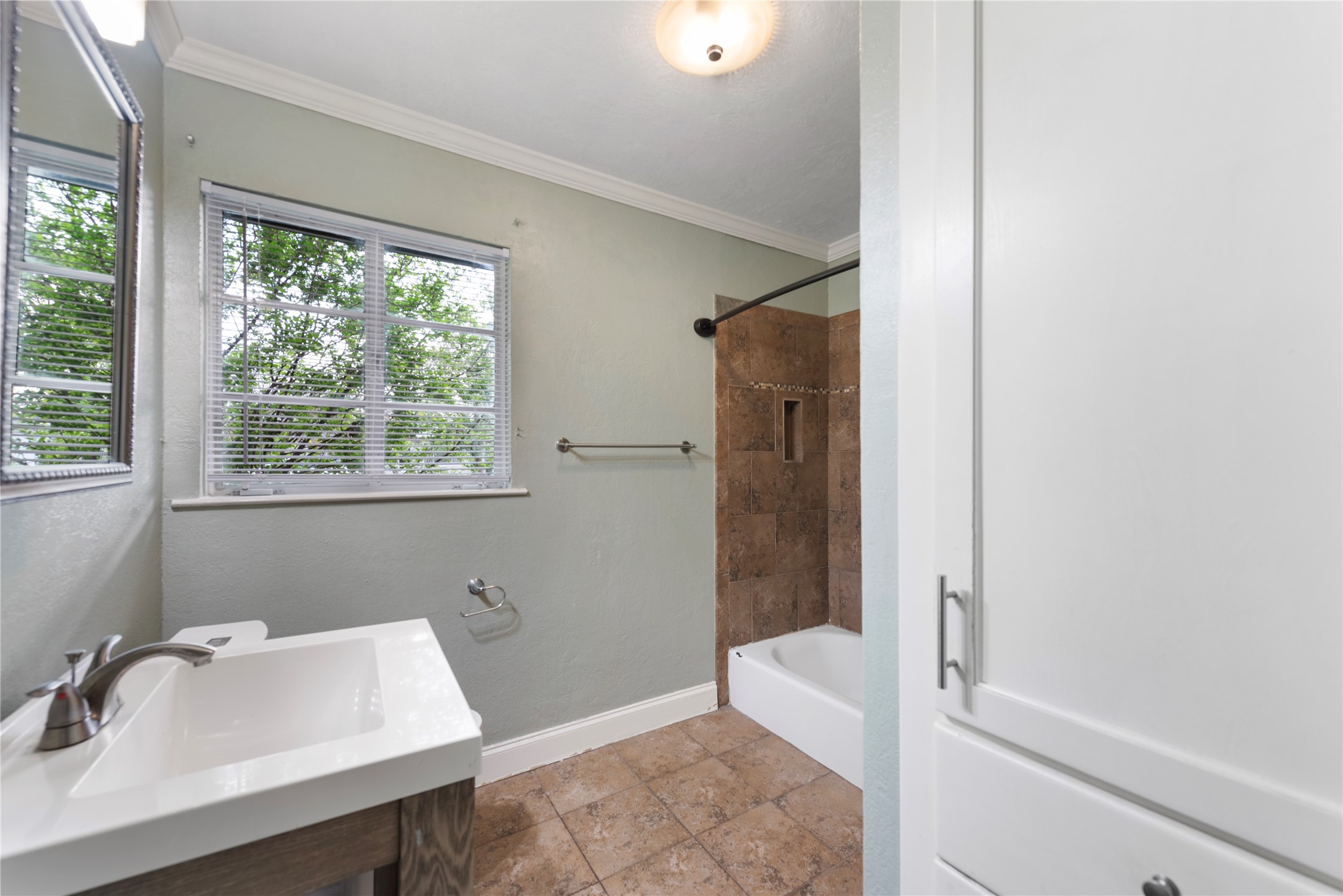 1900 Justin Lane Austin, TX 78757 - Photo 17 of 27 Bathroom featuring crown molding, shower / bathtub combination, and vanity