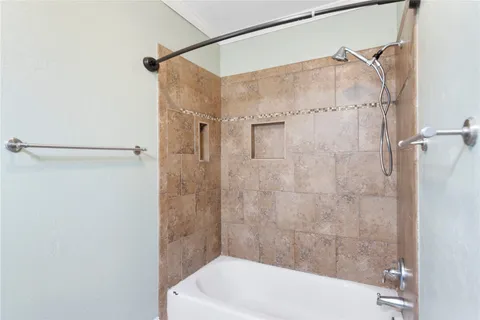 a bathroom with a white shower and a tub
