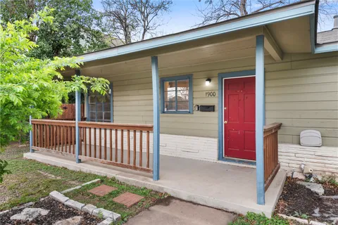 a view of a house with a backyard and porch