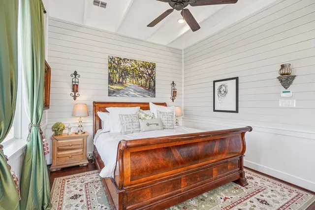 a bedroom with a bed and a large window