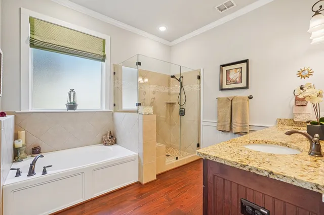 a bathroom with a granite countertop sink a mirror and a shower