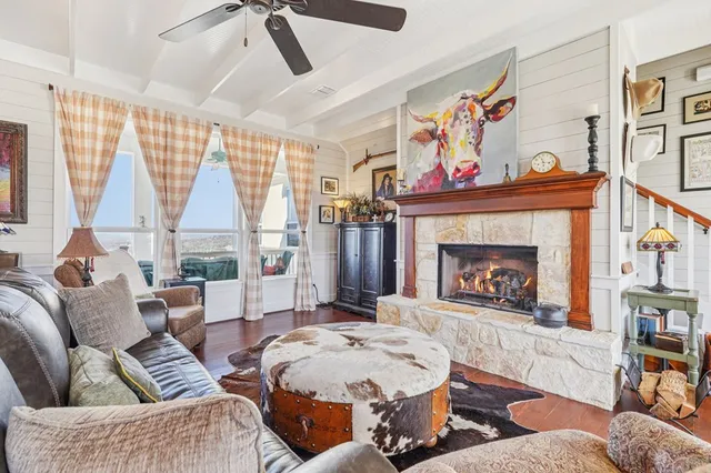 a living room with a fireplace furniture and a window