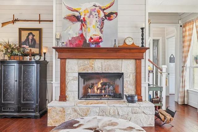 a view of a dining room and livingroom with furniture wooden floor and a chandelier