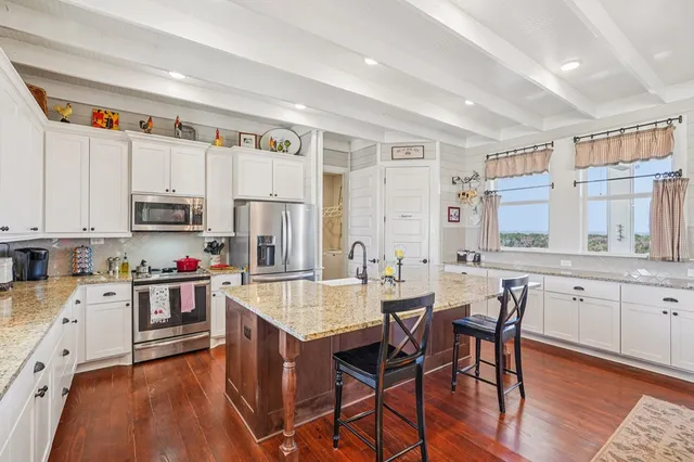 a view of kitchen with cabinets and wooden floor