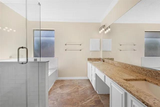 a spacious bathroom with a granite countertop sink a mirror and shower