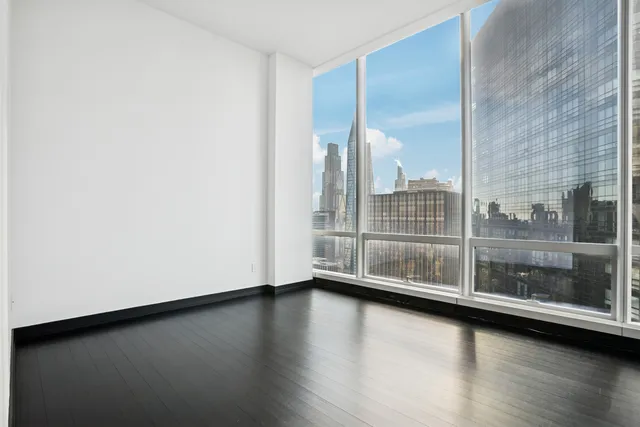a large white kitchen with a large window