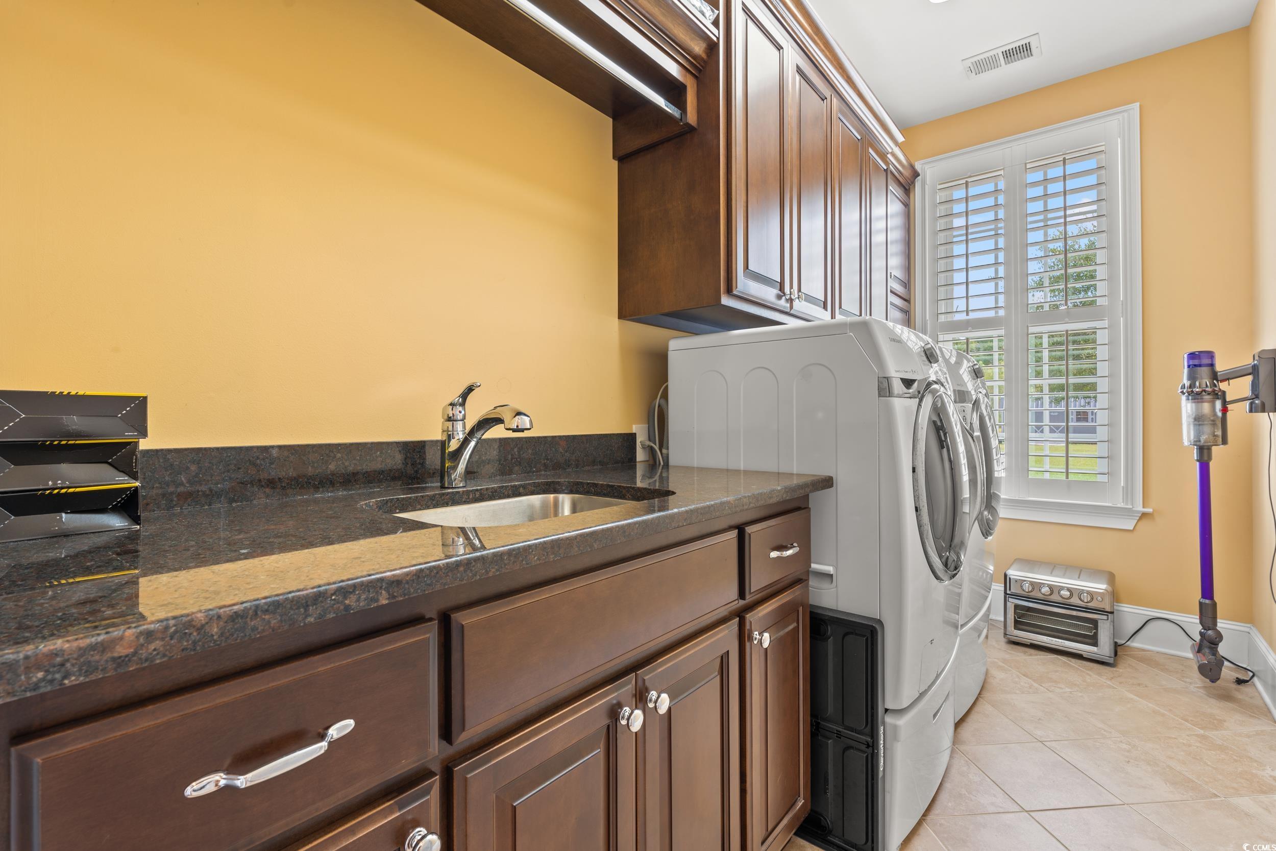 3609 Long Ave Extension Conway, SC 29526 - Photo 16 of 40 Laundry room with light tile patterned floors, cabinet space, and washer and clothes dryer