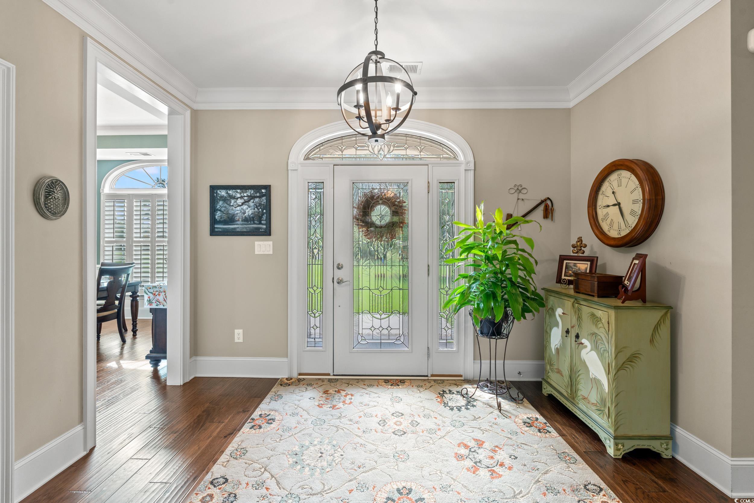 3609 Long Ave Extension Conway, SC 29526 - Photo 3 of 40 Foyer entrance featuring crown molding, a chandelier, and dark wood-style flooring