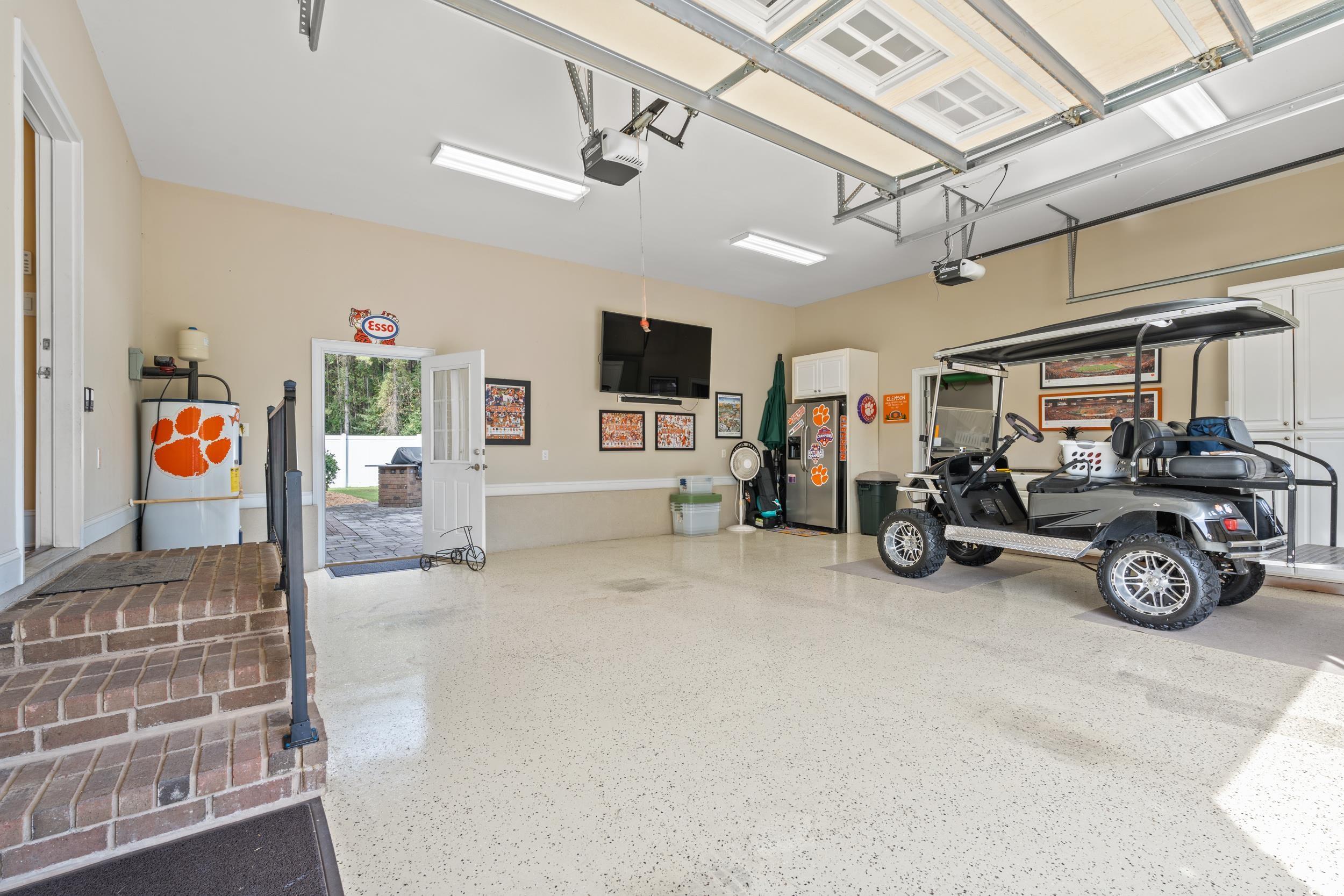 3609 Long Ave Extension Conway, SC 29526 - Photo 32 of 40 Garage featuring stainless steel fridge and a garage door opener