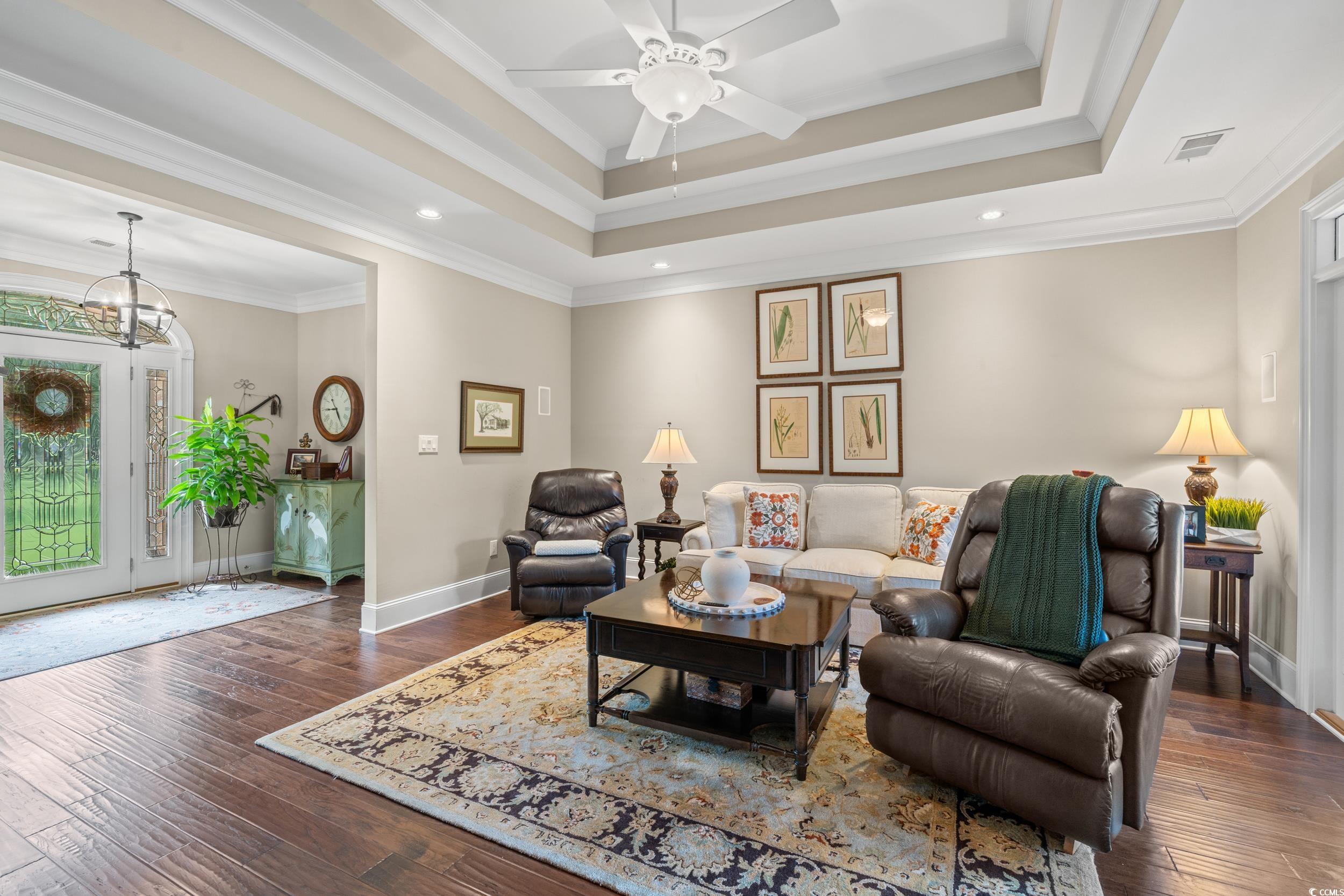 3609 Long Ave Extension Conway, SC 29526 - Photo 4 of 40 Living area featuring dark wood-style flooring, ornamental molding, a tray ceiling, ceiling fan, and recessed lighting