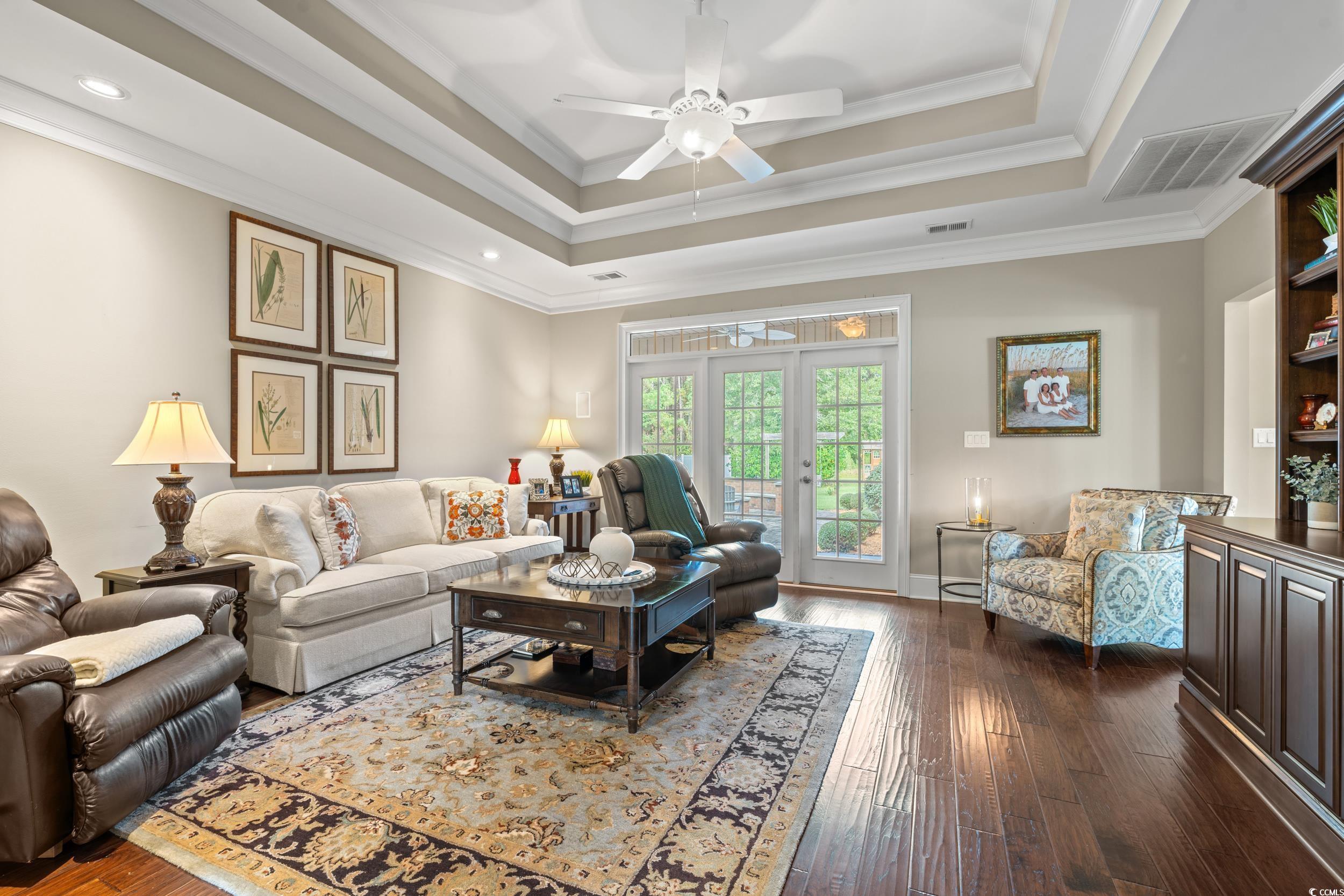 3609 Long Ave Extension Conway, SC 29526 - Photo 5 of 40 Living room with a tray ceiling, dark wood-type flooring, ornamental molding, ceiling fan, and recessed lighting