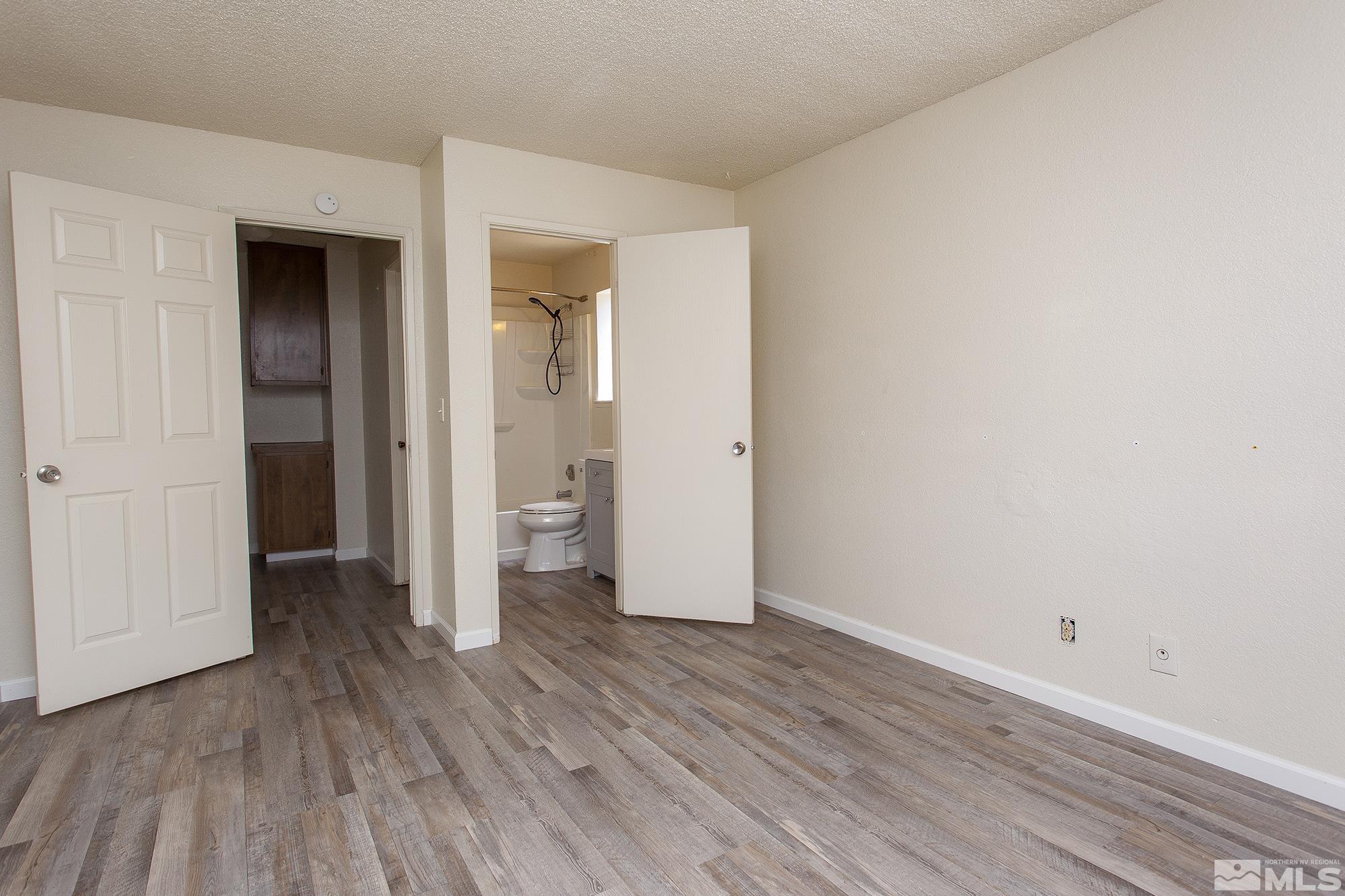 10046 Humite Lane Reno, NV 89506 - Photo 12 of 17 an empty room with wooden floor and closet