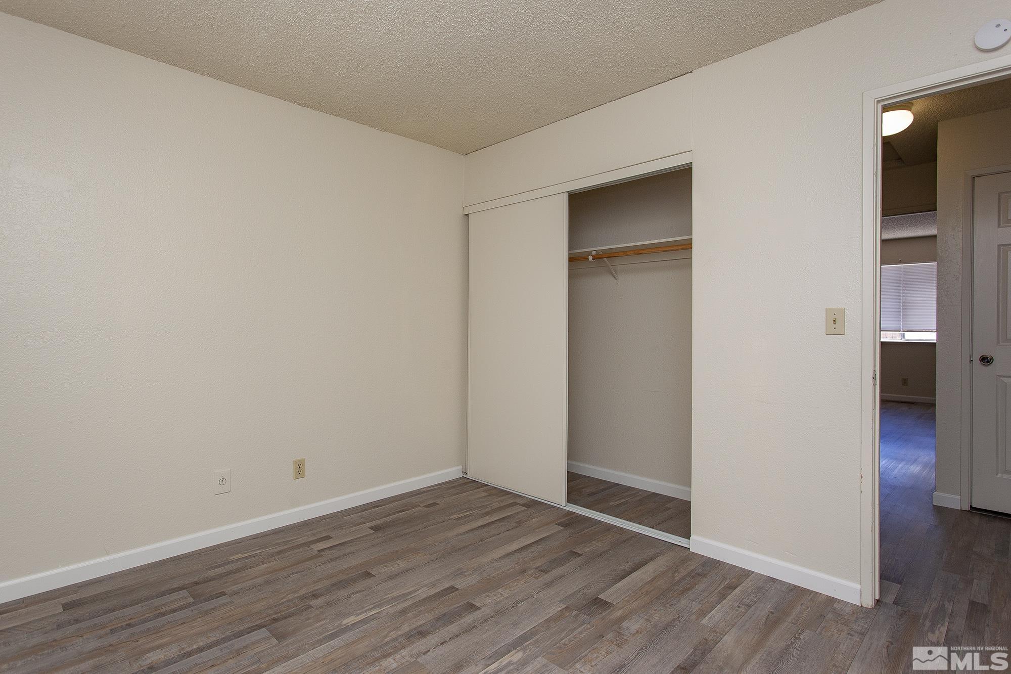 10046 Humite Lane Reno, NV 89506 - Photo 13 of 17 a view of empty room with wooden floor