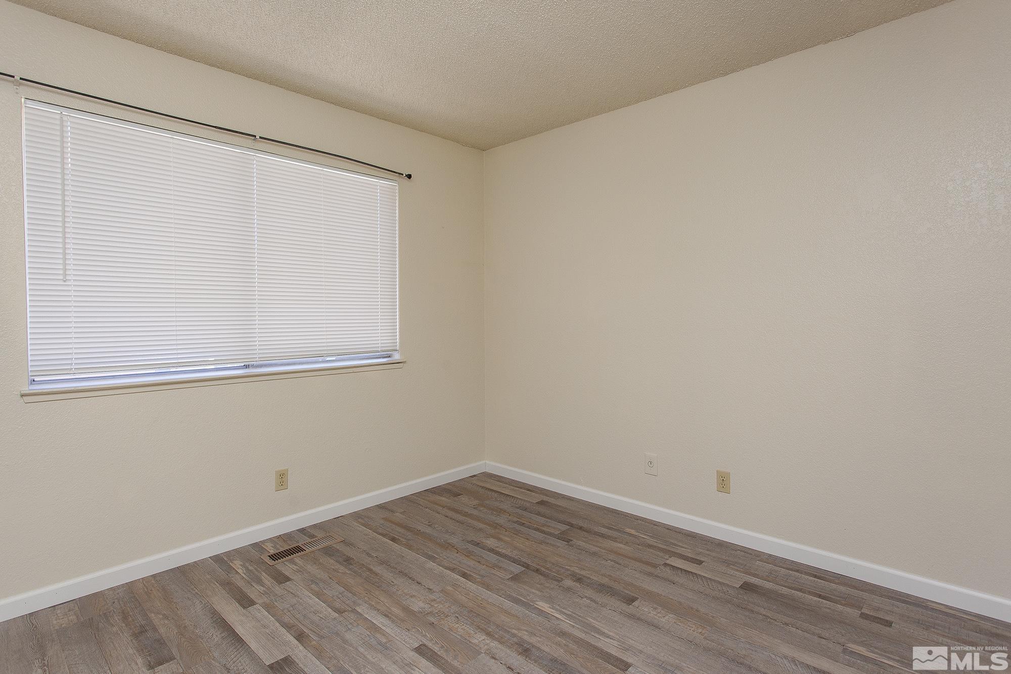 10046 Humite Lane Reno, NV 89506 - Photo 15 of 17 a view of a small space with wooden floor and a window
