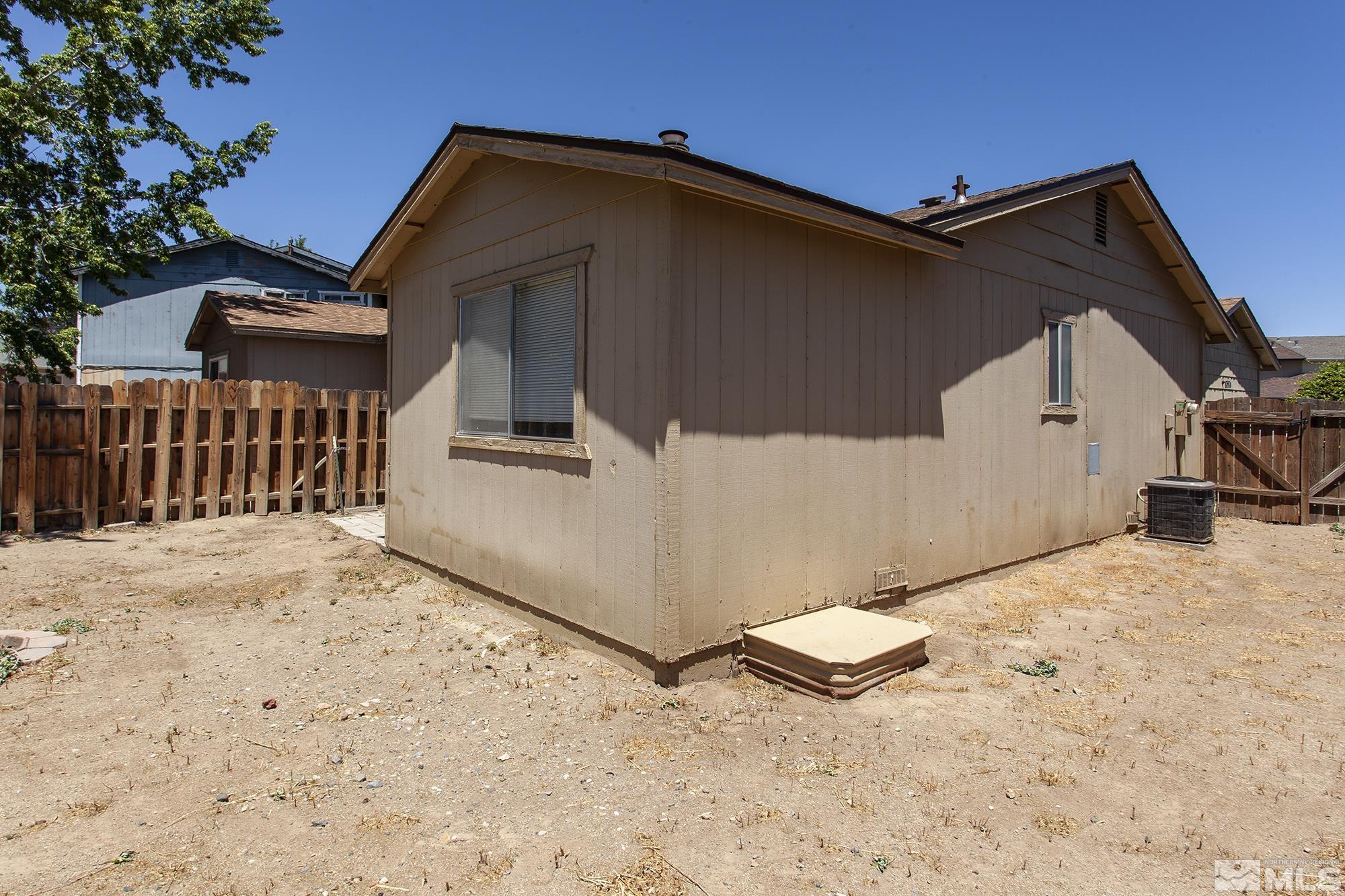 10046 Humite Lane Reno, NV 89506 - Photo 16 of 17 a view of a house with a yard