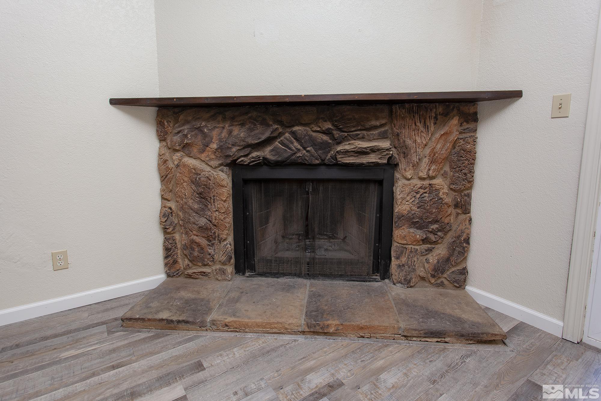 10046 Humite Lane Reno, NV 89506 - Photo 4 of 17 a room with a fireplace and wooden floor