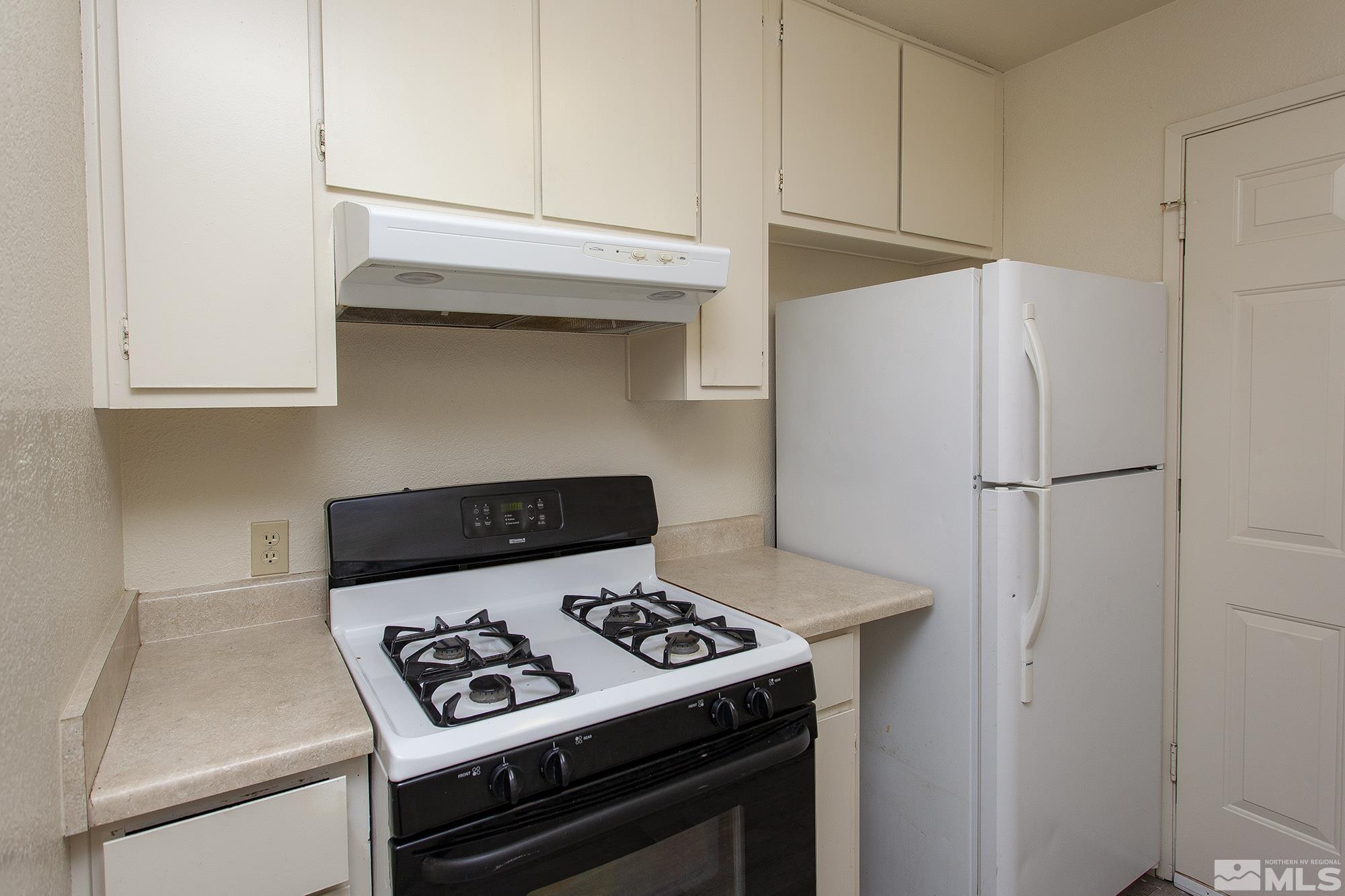 10046 Humite Lane Reno, NV 89506 - Photo 6 of 17 a stove top oven sitting inside of a kitchen