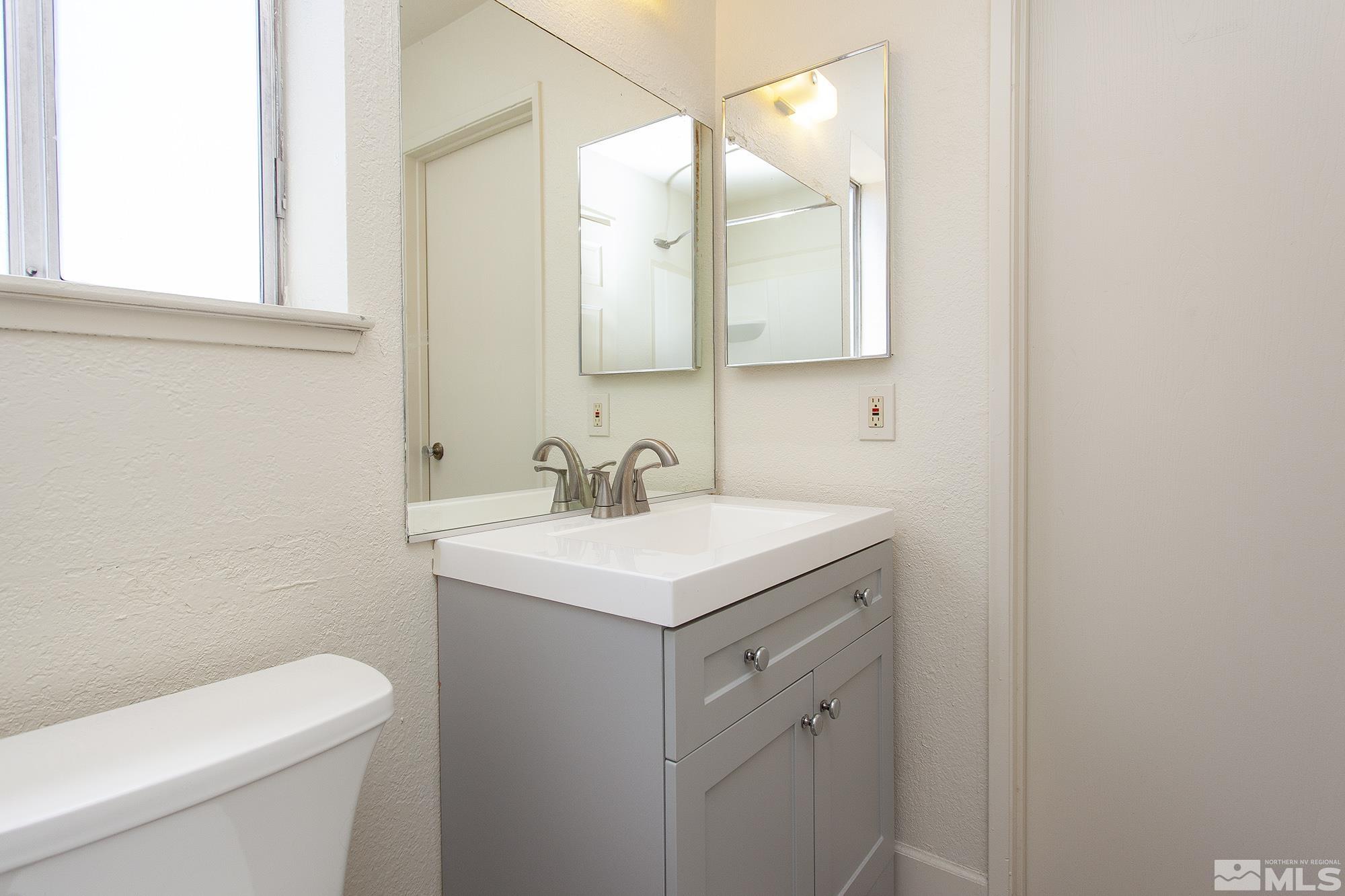 10046 Humite Lane Reno, NV 89506 - Photo 8 of 17 a bathroom with a toilet sink and mirror