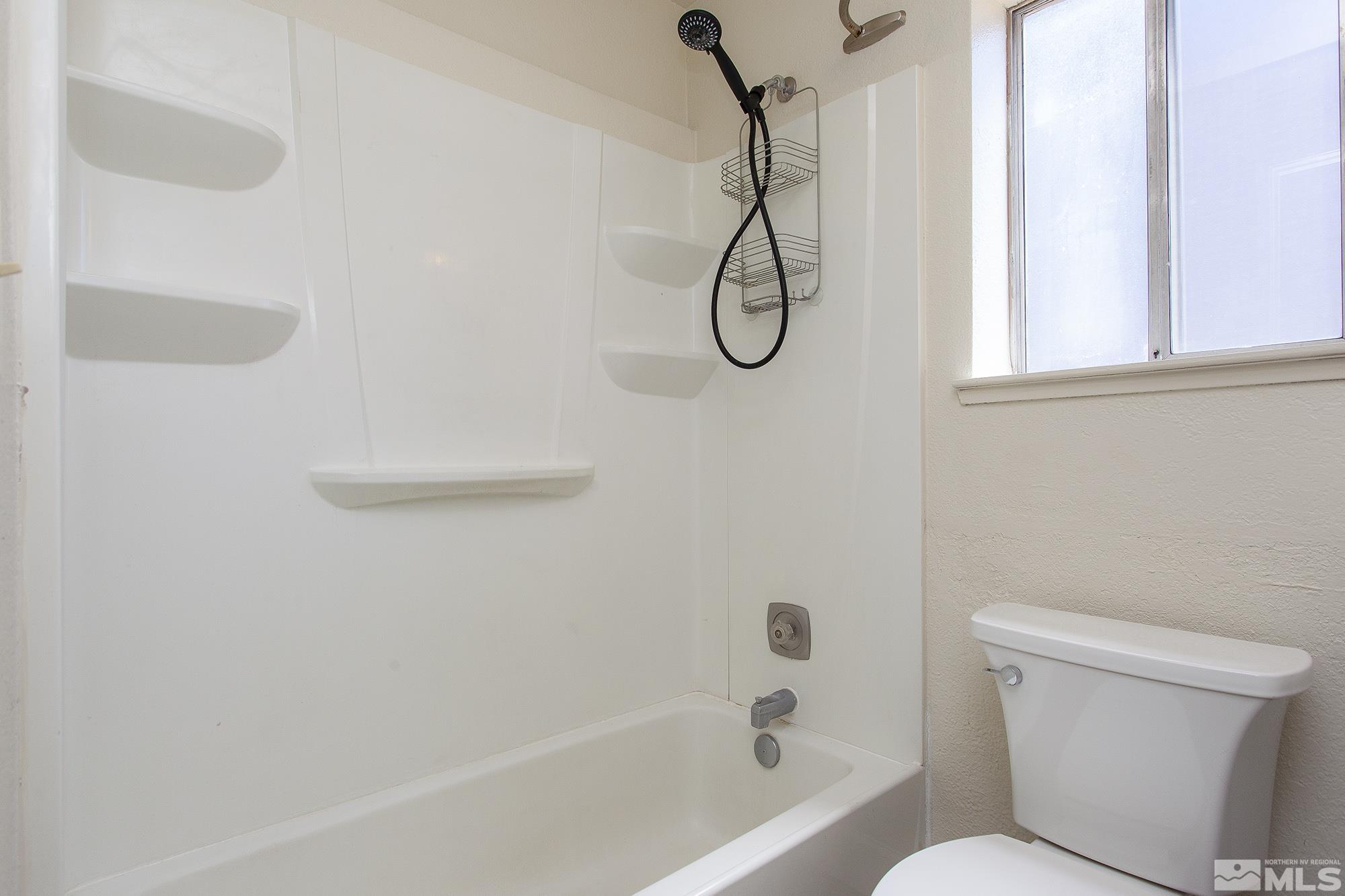 10046 Humite Lane Reno, NV 89506 - Photo 9 of 17 a bathroom with a shower and a toilet