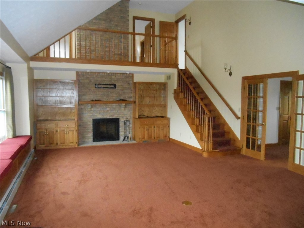 800 Bell Road Wooster, OH 44691 - Photo 8 of 33 Living Room with built-ins and view of dual entry doors to second floor bedroom. One door on each side of the chimney. Also, the door to the right is the entry to the storage area.