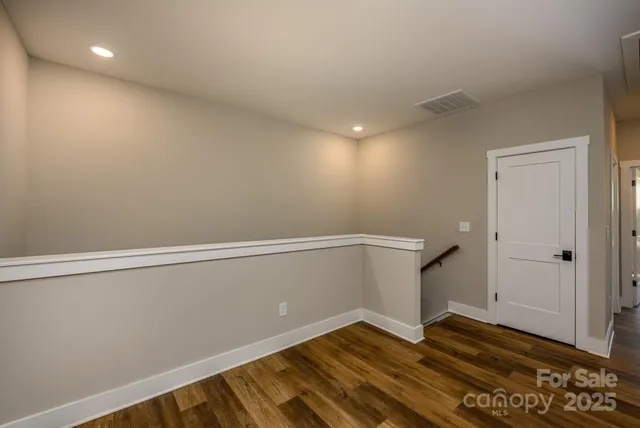 a view of room with wooden floor