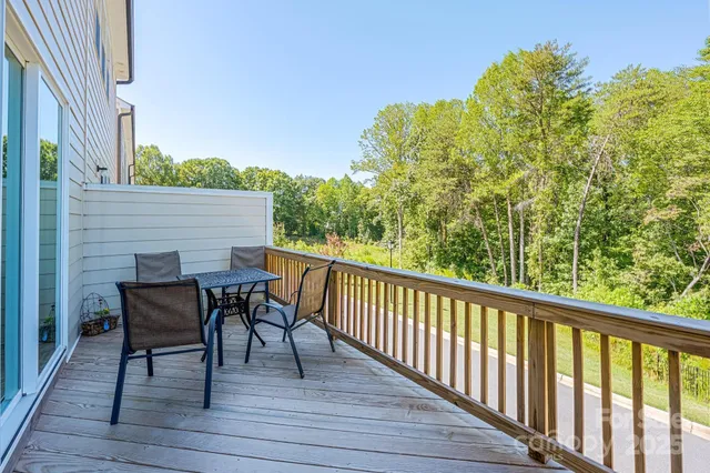 a view of a deck with table and chairs and wooden floor