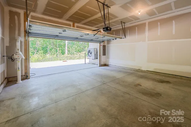 a view of empty room with wooden floor and windows