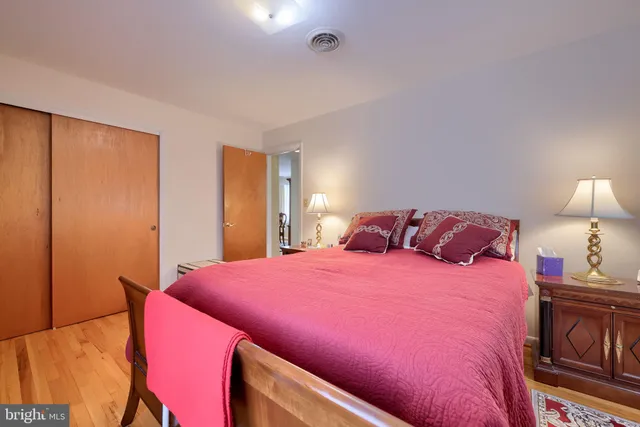 a bedroom with a bed and a lamp