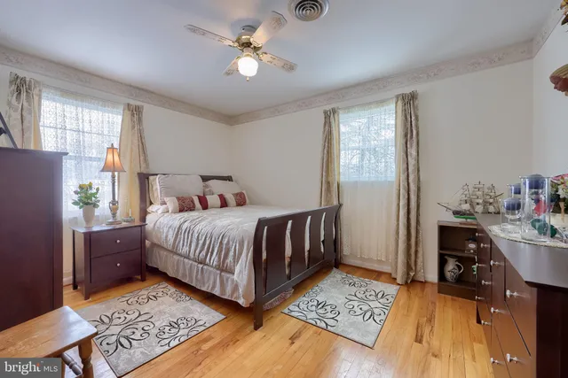 a bedroom with a bed chandelier and a window