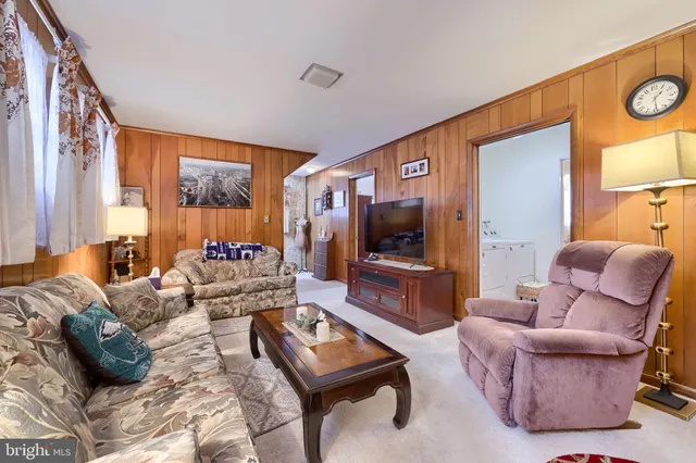 a living room with furniture fireplace and a large window
