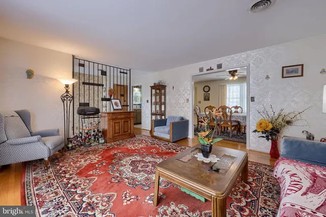 a living room with furniture a rug and a table