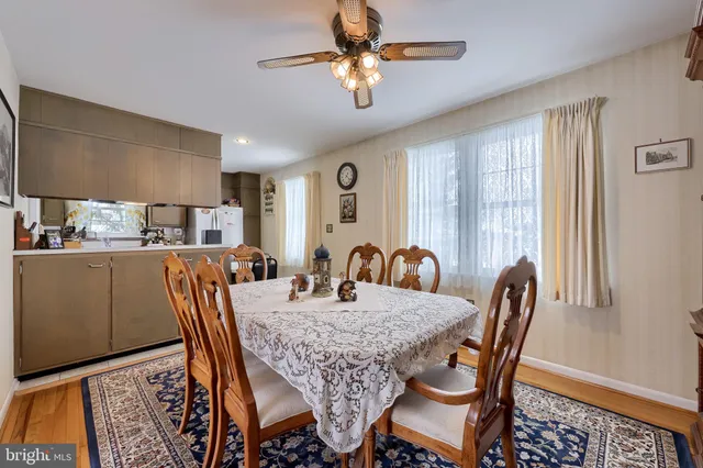 a view of a a dining room with furniture and a window