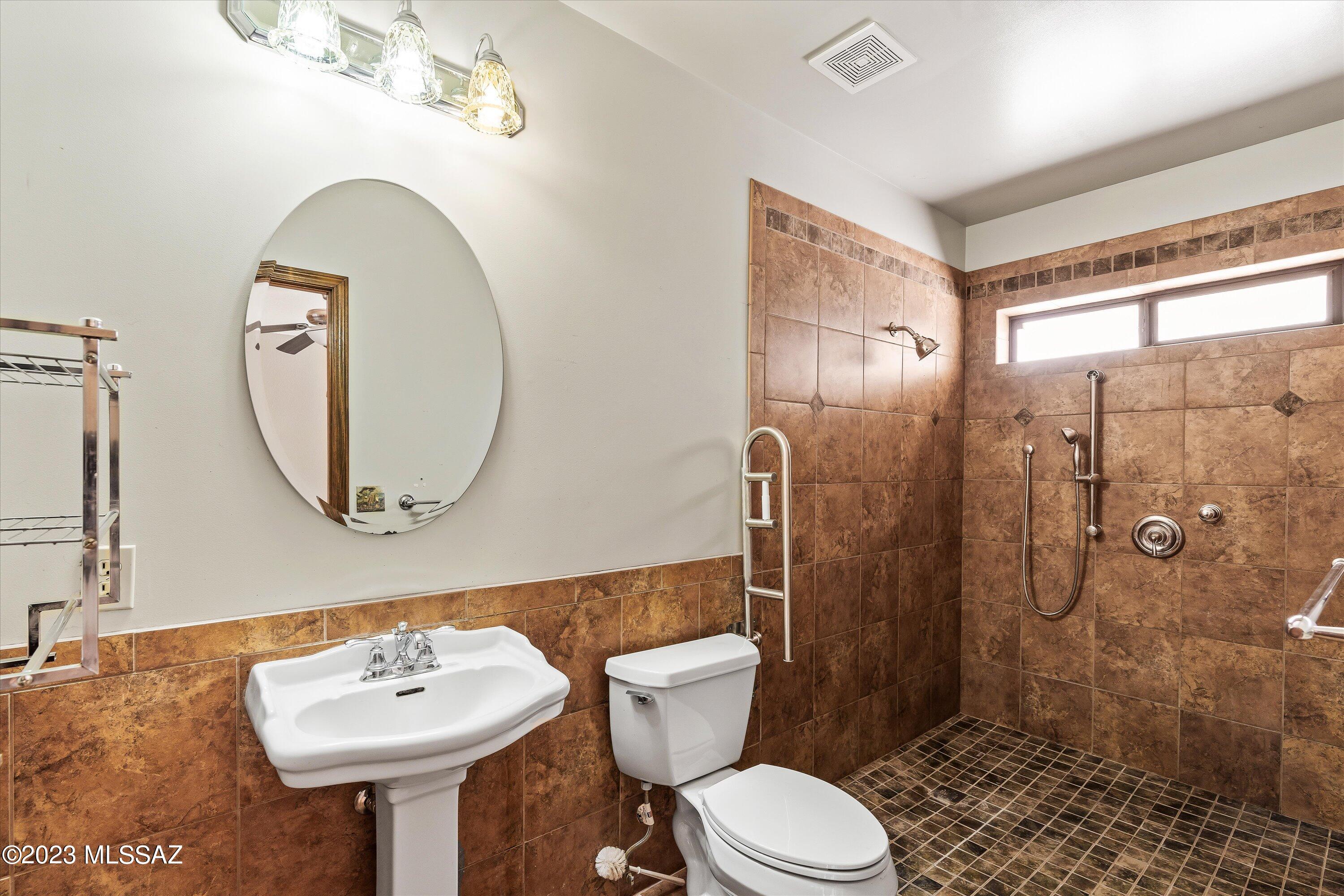 1226 Avenida Gloriosa Rio Rico, AZ 85648 - Photo 17 of 46 a bathroom with a toilet sink and mirror
