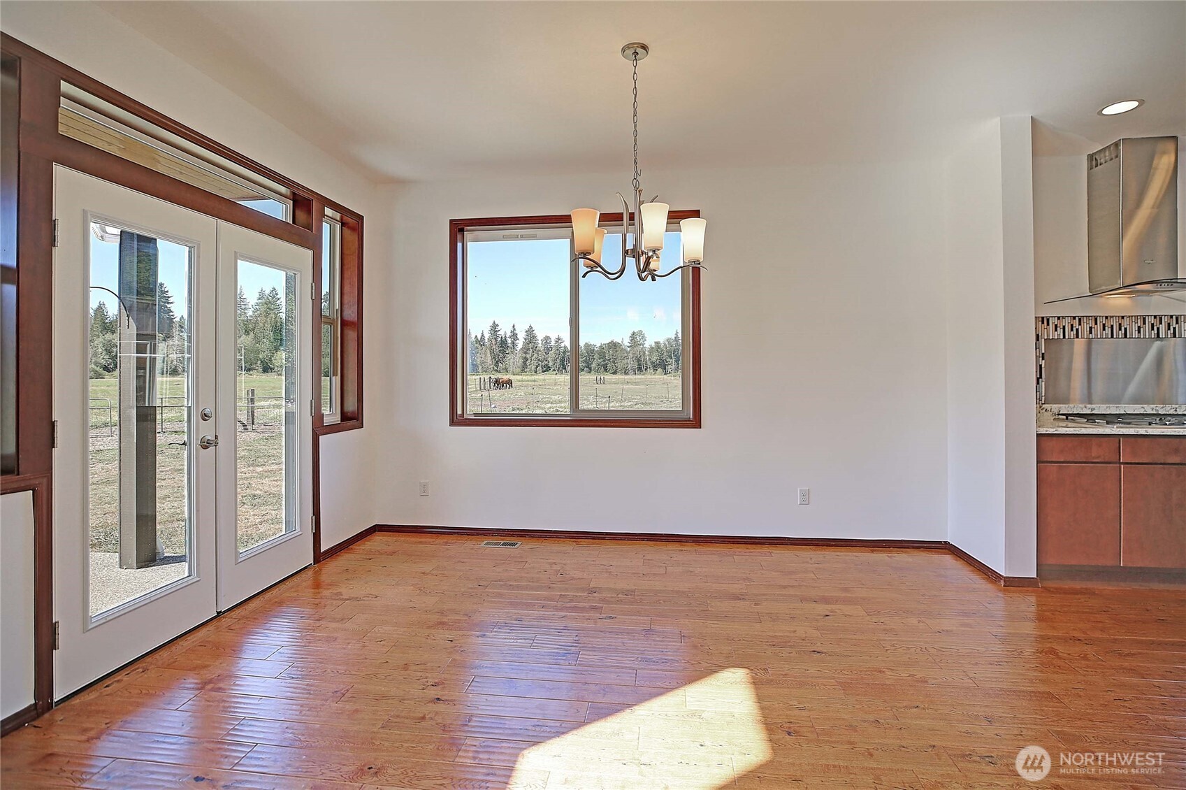 12631 State Rte 530 Northeast Arlington, WA 98223 - Photo 12 of 40 a view of an empty room with wooden floor and a window