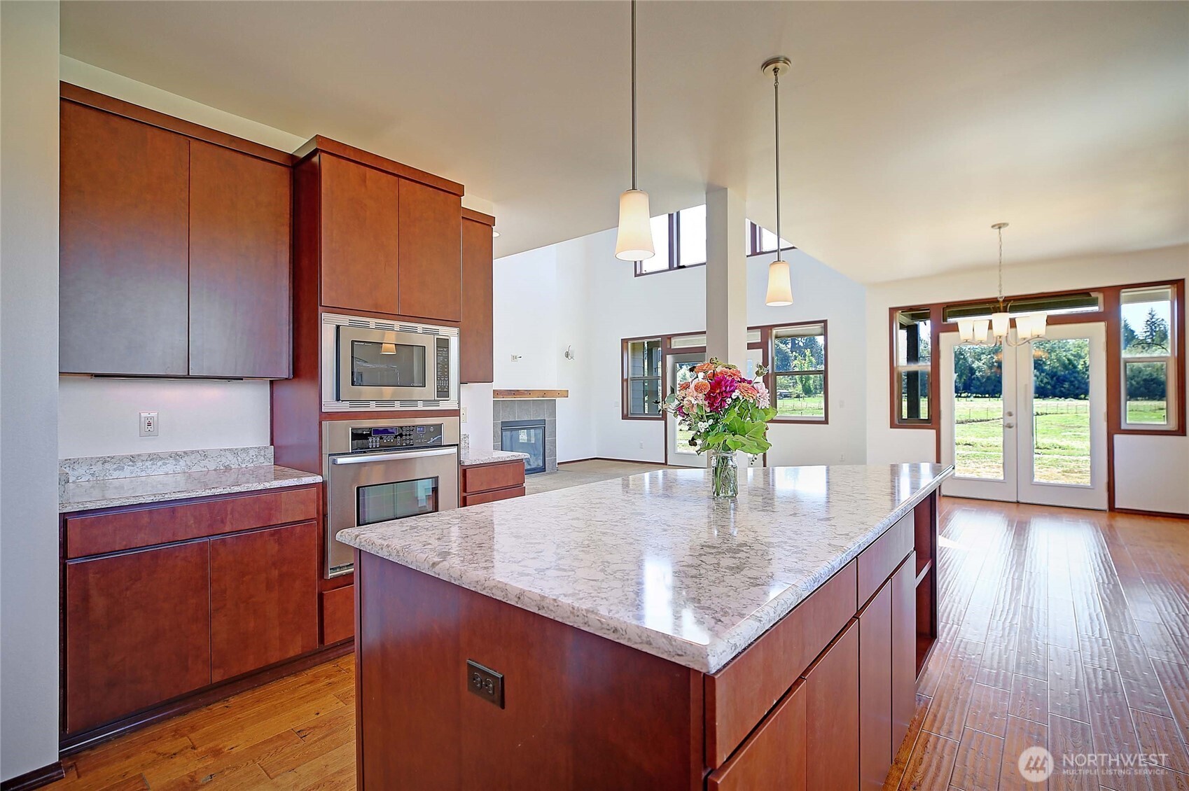 12631 State Rte 530 Northeast Arlington, WA 98223 - Photo 14 of 40 a kitchen with stainless steel appliances granite countertop a kitchen island a stove a sink a counter space and cabinets