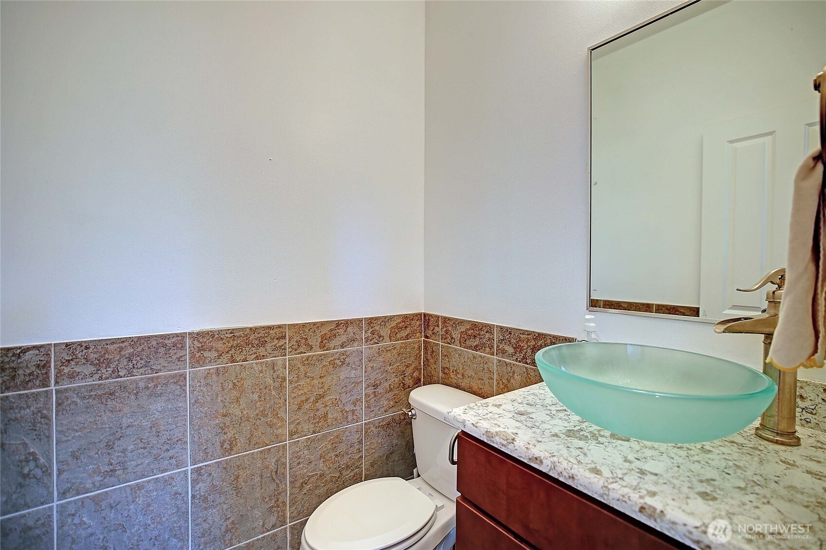 12631 State Rte 530 Northeast Arlington, WA 98223 - Photo 16 of 40 a bathroom with a granite countertop toilet and a sink