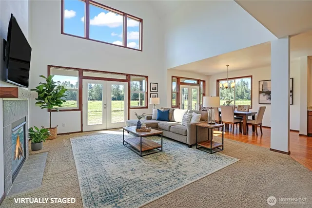 a living room with furniture large window and flat screen tv