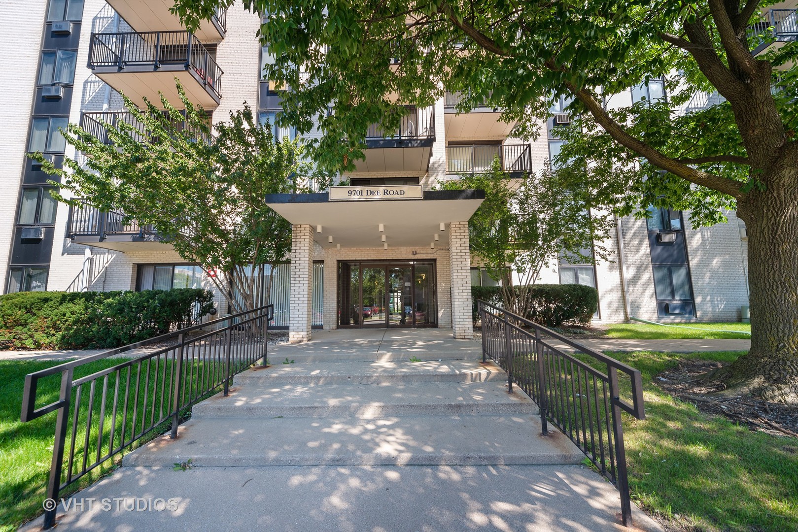 9701 North Dee Road, Unit 3L Niles, IL 60714 - Photo 1 of 10 a front view of a house with a yard and an trees
