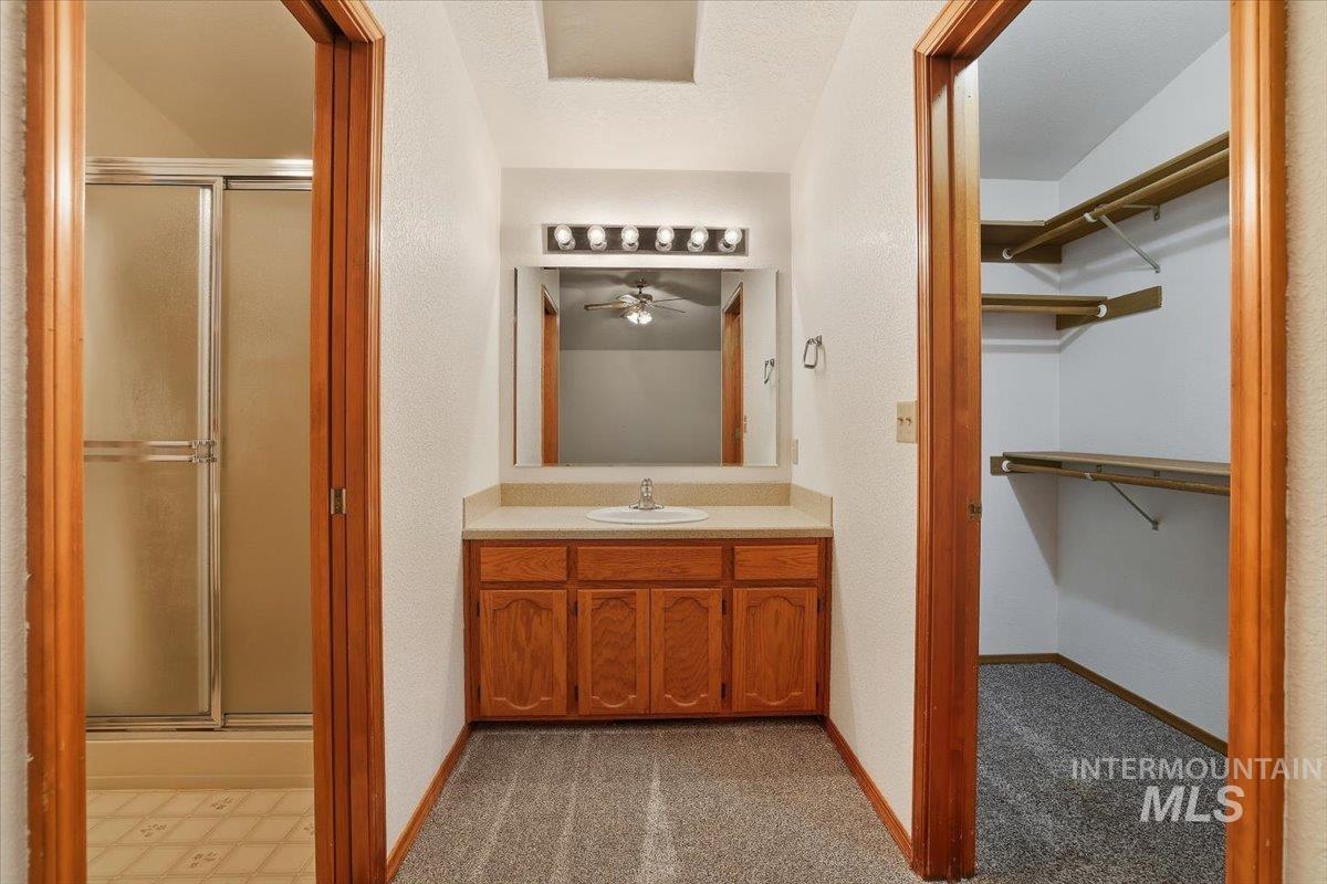 7134 West Amity Road Boise, ID 83709 - Photo 15 of 20 Full bathroom with a spacious closet, vanity, and a stall shower