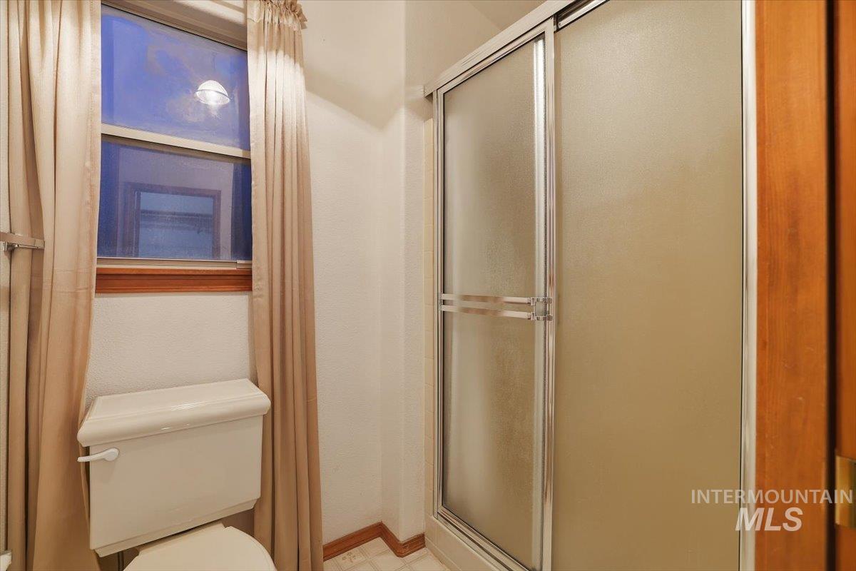 7134 West Amity Road Boise, ID 83709 - Photo 16 of 20 Full bathroom with a shower stall and toilet