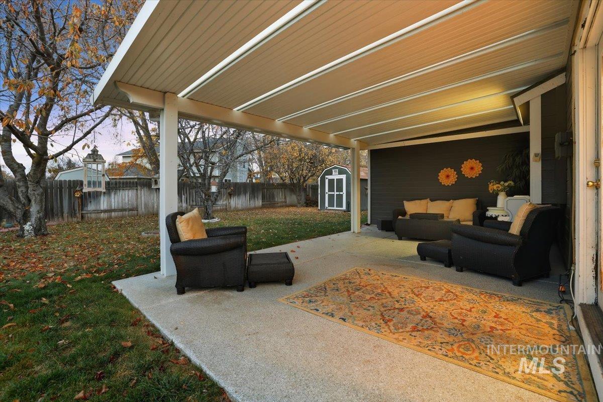 7134 West Amity Road Boise, ID 83709 - Photo 20 of 20 Fenced backyard with a patio area, an outdoor hangout area, and a shed