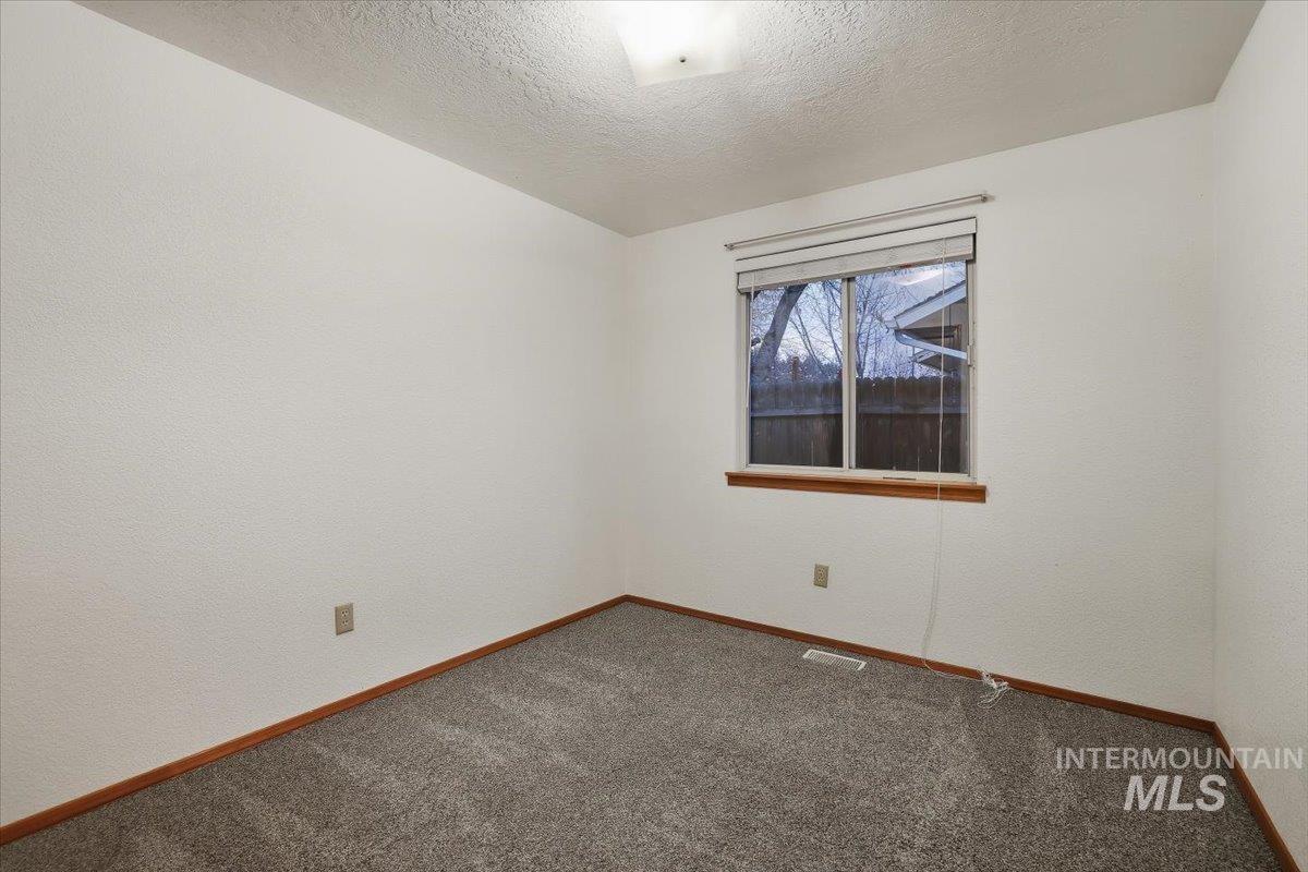 7134 West Amity Road Boise, ID 83709 - Photo 10 of 20 Spare room featuring a textured ceiling and carpet floors