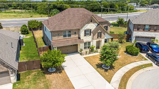 an aerial view of a house with a garden and lake view