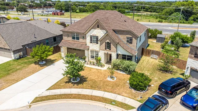 an aerial view of a house with a swimming pool patio and lake view