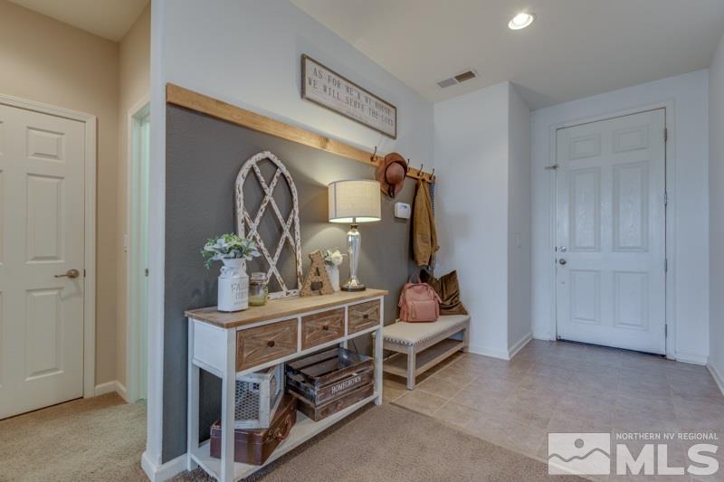 9150 Andraste Way Reno, NV 89506 - Photo 3 of 23 a living room with furniture and a mirror