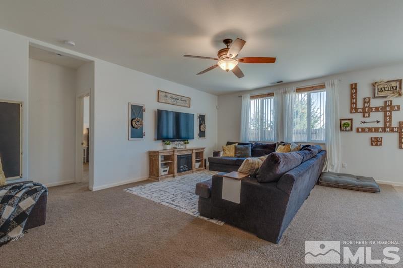 9150 Andraste Way Reno, NV 89506 - Photo 4 of 23 a living room with furniture and a flat screen tv